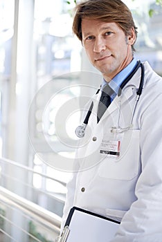 Doctor, smile and clipboard in hospital for checklist, report or patient records in portrait. Medical professional, face