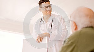 Doctor smiling kindly at an older man