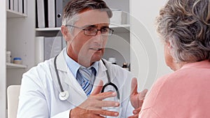 Doctor speaking with his patient at desk