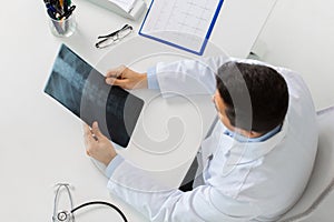 Doctor with spine x-ray sitting at table