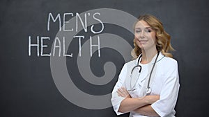 Doctor standing near Mens health inscription, importance of annual physical exam