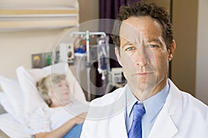 Doctor Standing In Patients Room