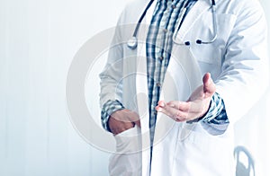 The doctor standing and put his hand in his pocket in the medical room for concept Ideal about diagnosis with modern medicine