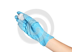 Doctor in sterile glove holding medical cotton ball