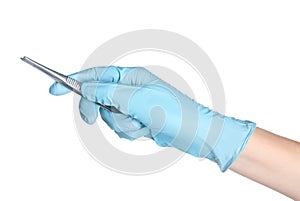 Doctor in sterile glove holding medical forceps