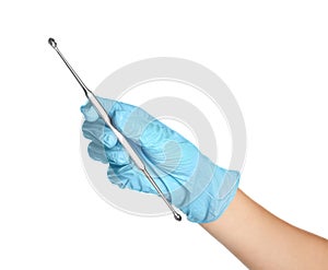 Doctor in sterile glove holding medical tool