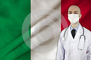 Doctor with a stethoscope on the background of the silk national flag of italy, concept of national medical care, health,