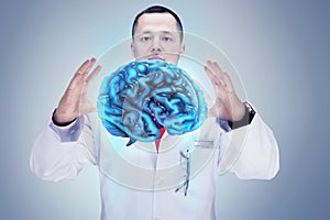 Doctor with stethoscope and brains on the hands. gray background. High resolution. photo