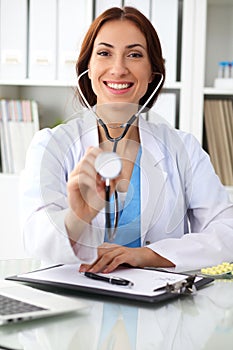 Doctor with stethoscope in the hands, cheerful smilling. Physician ready to examine and help patient. Medicin