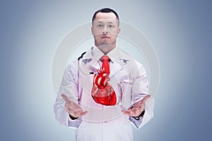 Doctor with stethoscope and heart on the hands in a hospital. High resolution.