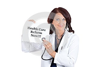 Doctor with stethoscope holding health care reform now sign photo