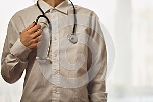 doctor with a stethoscope on hospital background.