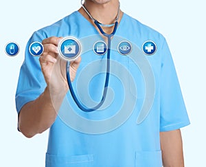 Doctor with stethoscope and informational icons on light background. Medical service