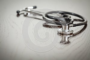 Doctor Stethoscope Laying on a Reflective Table