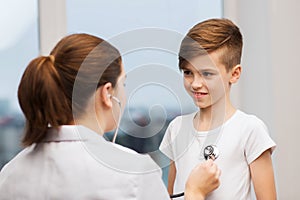 Doctor with stethoscope listening to happy child