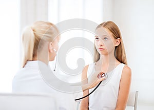 Doctor with stethoscope listening to the patient