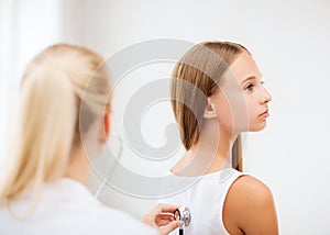 Doctor with stethoscope listening to the patient