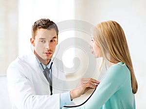 Doctor with stethoscope listening to the patient