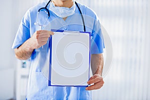 Doctor with stethoscope and medical card