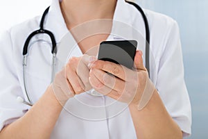 Doctor with stethoscope and mobile phone