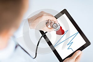 Doctor with stethoscope and tablet pc