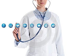 Doctor with stethoscope and virtual icons against white background.