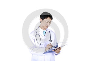 doctor with stethoscope writing on a medical record chart