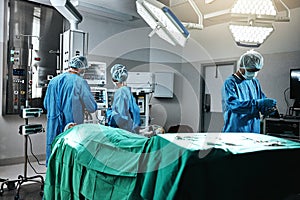 Doctor, surgeon and employees in hospital, theater and emergency room busy in medical career. People, healthcare workers