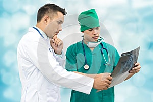 Doctor and surgeon looking at x-ray film