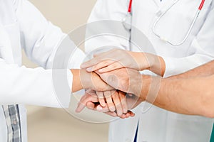 Doctor, surgeon and nurse join hands together