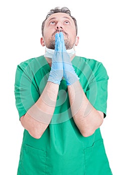 Doctor or surgeon praying