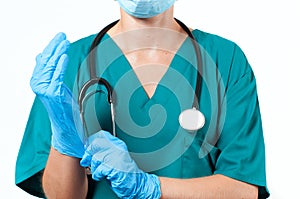 Doctor surgeon in sterile mask is wearing gloves before surgery