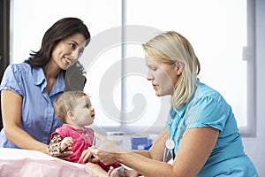 Doctor In Surgery Giving Baby Girl Injection