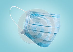 Doctor surgery mask, corona virus protection concept on blue background. Breathing medical respiratory textile protective mask