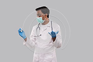 Doctor Surprised Holding Thermometer Wearing Medical Mask And Gloves. Indian Man Doctor Science, Medical Concept