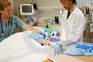 Doctor suturing patients arm