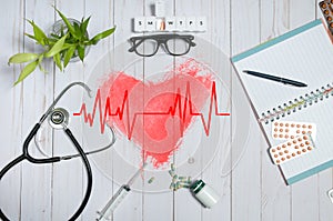 Doctor table with medical items, stethoscope and pills