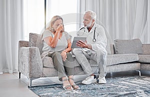 Doctor, tablet and bad news with a woman patient in the living room of her home with a medicine professional. Healthcare