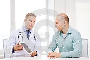 Doctor with tablet pc and patient in hospital