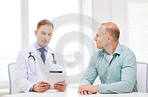 Doctor with tablet pc and patient in hospital