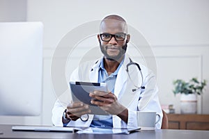 Doctor, tablet and portrait of black man at desk in hospital for medical insurance, networking or online consult. Smile
