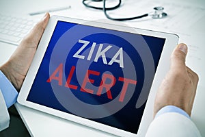 Doctor with a tablet with the text zika alert