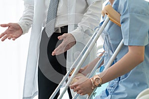 Doctor takes care of patient in crutch at hospital