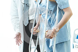 Doctor takes care of patient in crutch at hospital