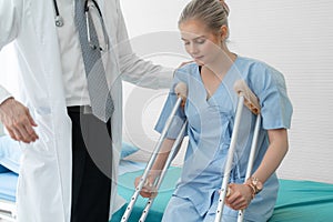 Doctor takes care of patient in crutch at hospital