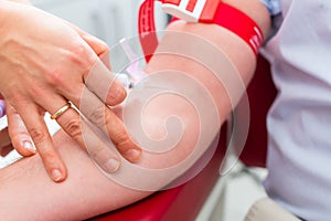 Doctor taking blood sample