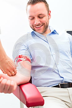 Doctor taking blood sample