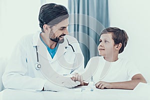 Doctor Taking Blood Sample from Boy`s Finger.