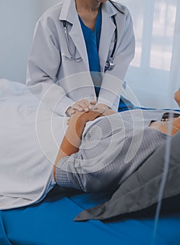 Doctor taking care, help and encourage Asian elder senior woman patient in clinic hospital