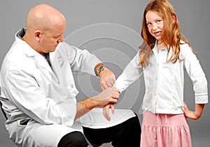 Doctor taking girl's pulse